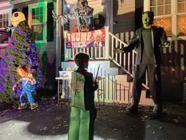 Lego ninjago outfit trick or treat kif stands in front of frightening statues on halloween night