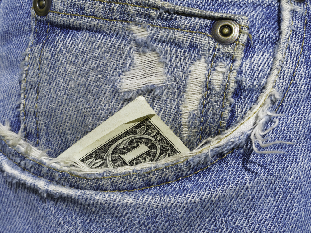 worn jeans with dollar bill in the pocket