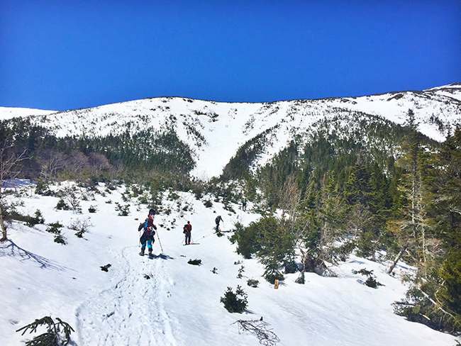 Skiers make the winter ascent to Mt Washington's Tuckerman Ravine in New Hampshire